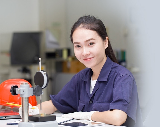 Woman smiling while working with machine